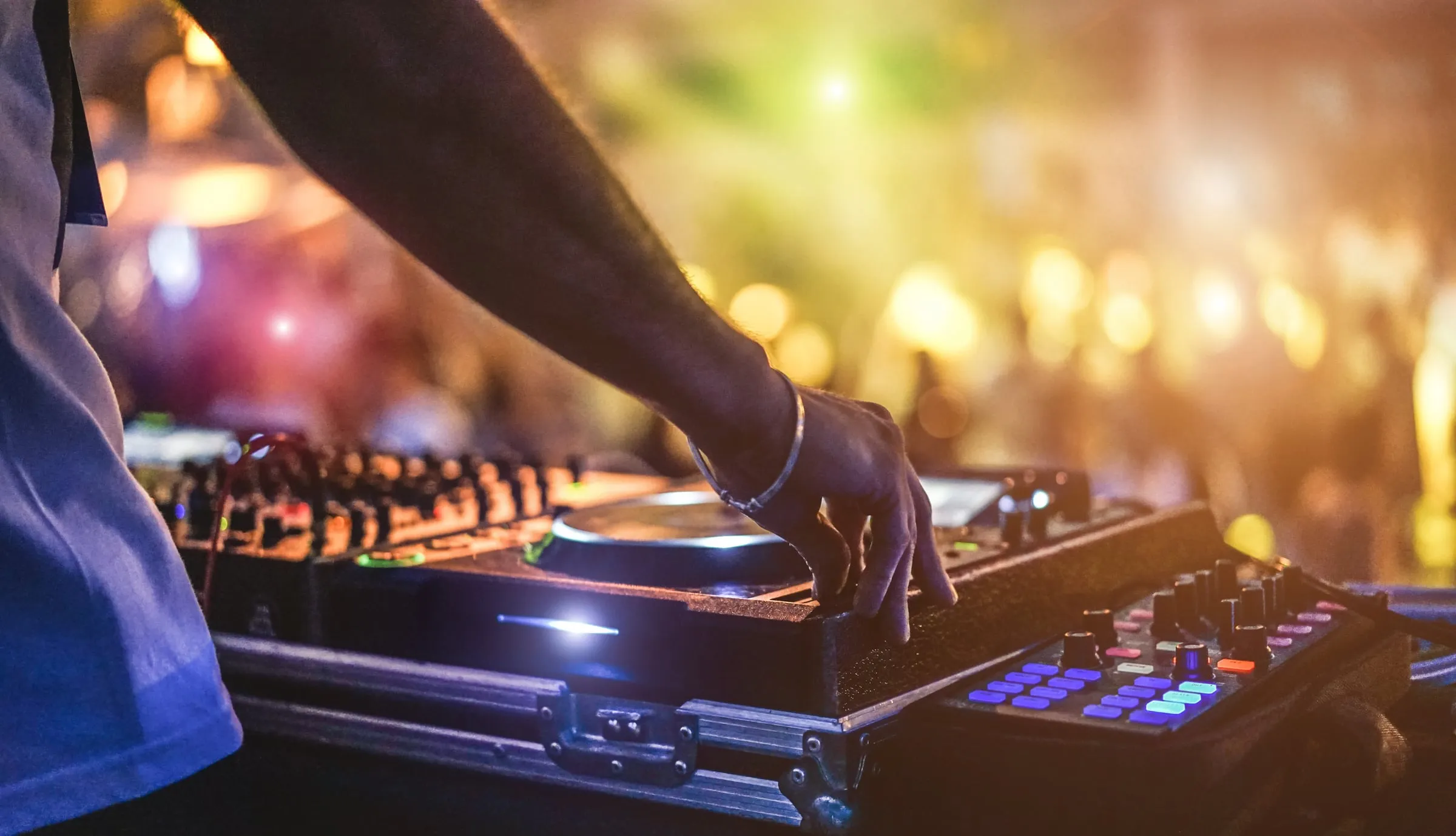 DJ performing at an Ibiza club with crowd in the background