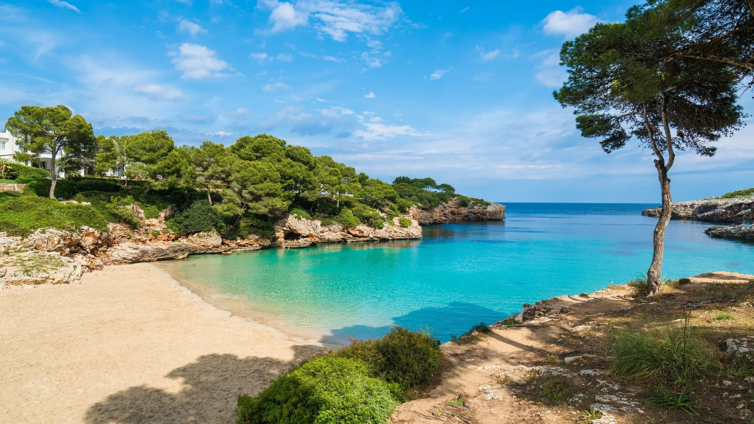 The beautiful protected bay of Cala Gran with families enjoying calm waters