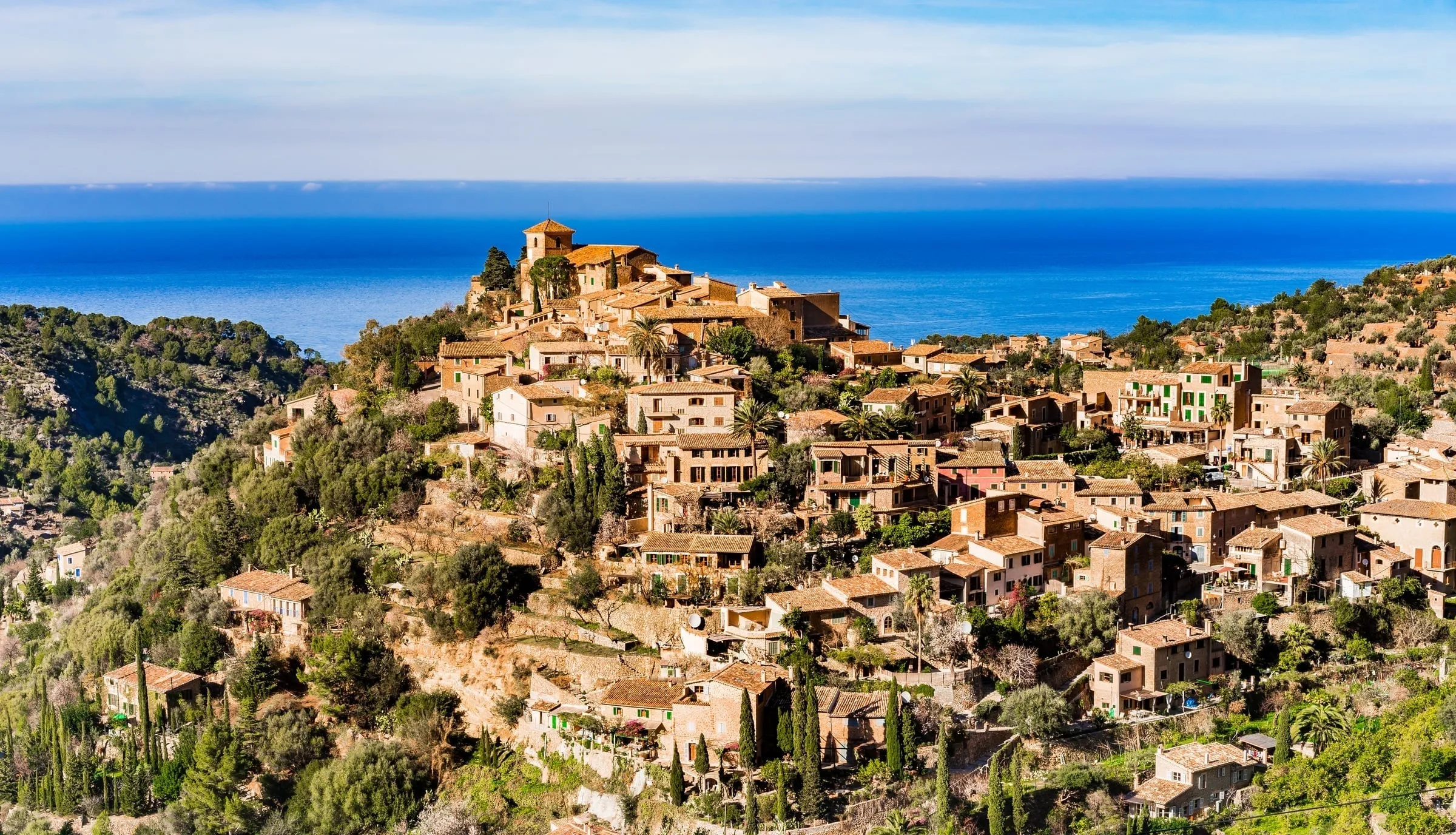 Deià village cascading down hillside to the sea