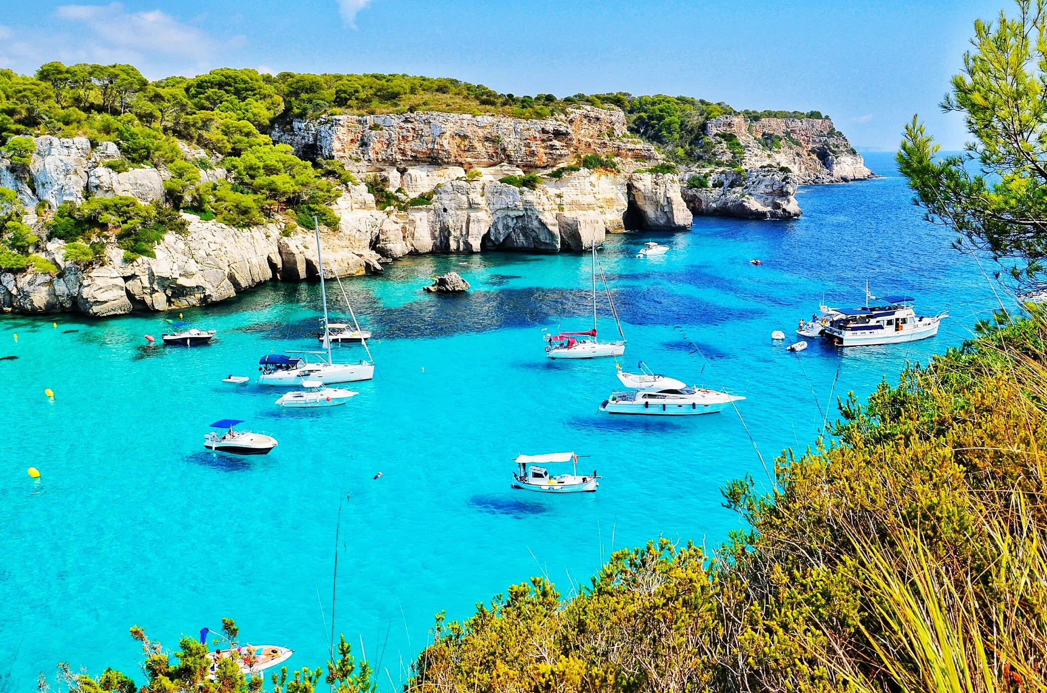 Aerial view of Cala Macarella and Macarelleta showing both turquoise coves surrounded by pine forests and limestone cliffs